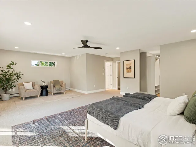 a bedroom with a bed and potted plant
