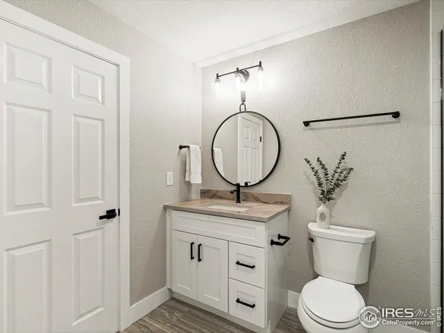 a bathroom with a toilet a sink and a mirror