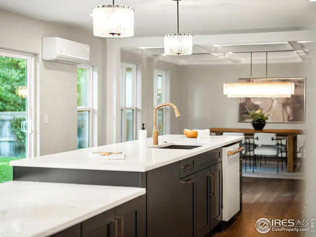 a kitchen with a counter space appliances and a dining table