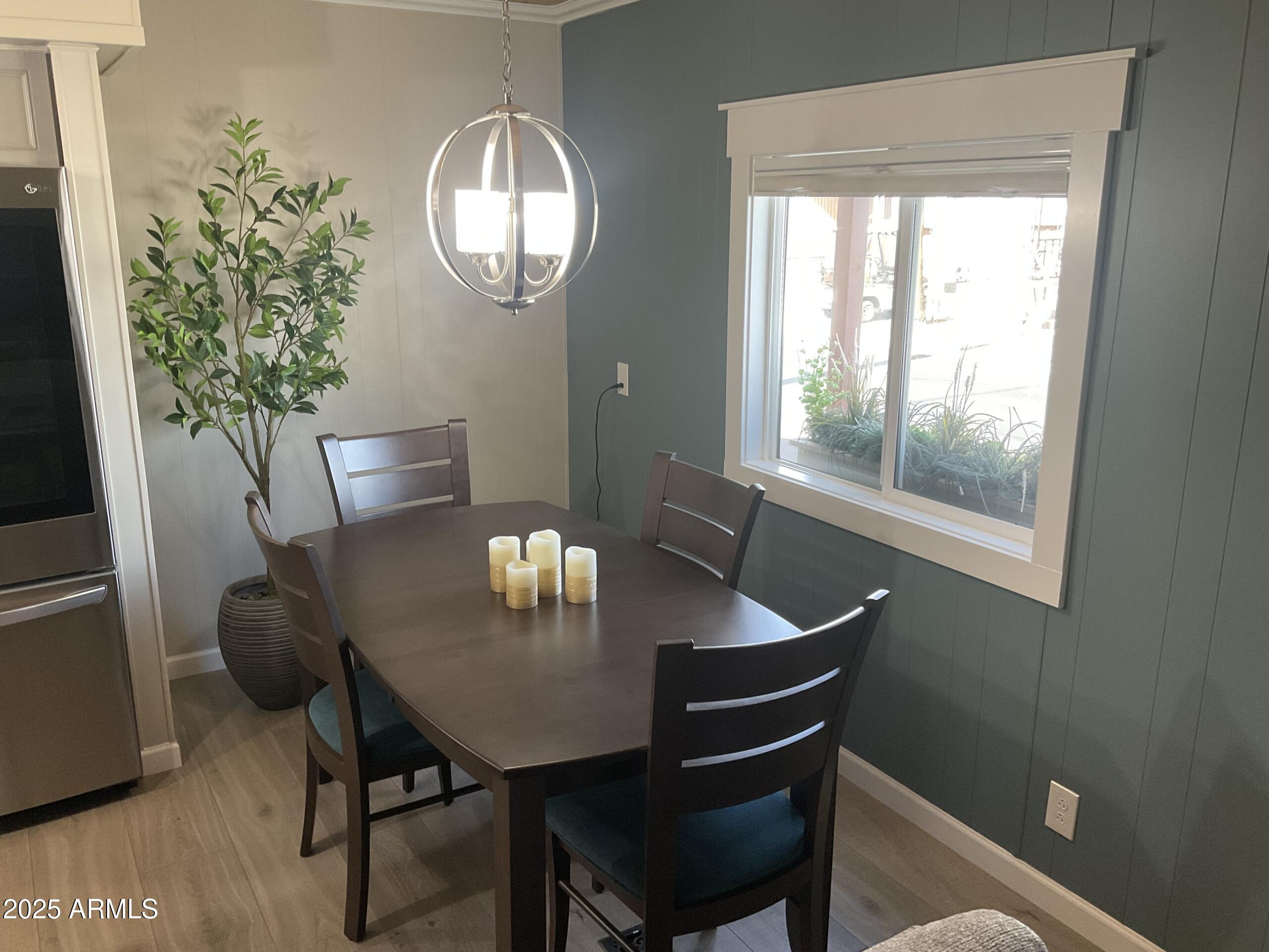 2175 West Southern Avenue, Unit 203 Apache Junction, AZ 85120 - Photo 13 of 28 a view of a dining room with furniture window and wooden floor
