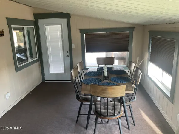 a dining room with furniture and window