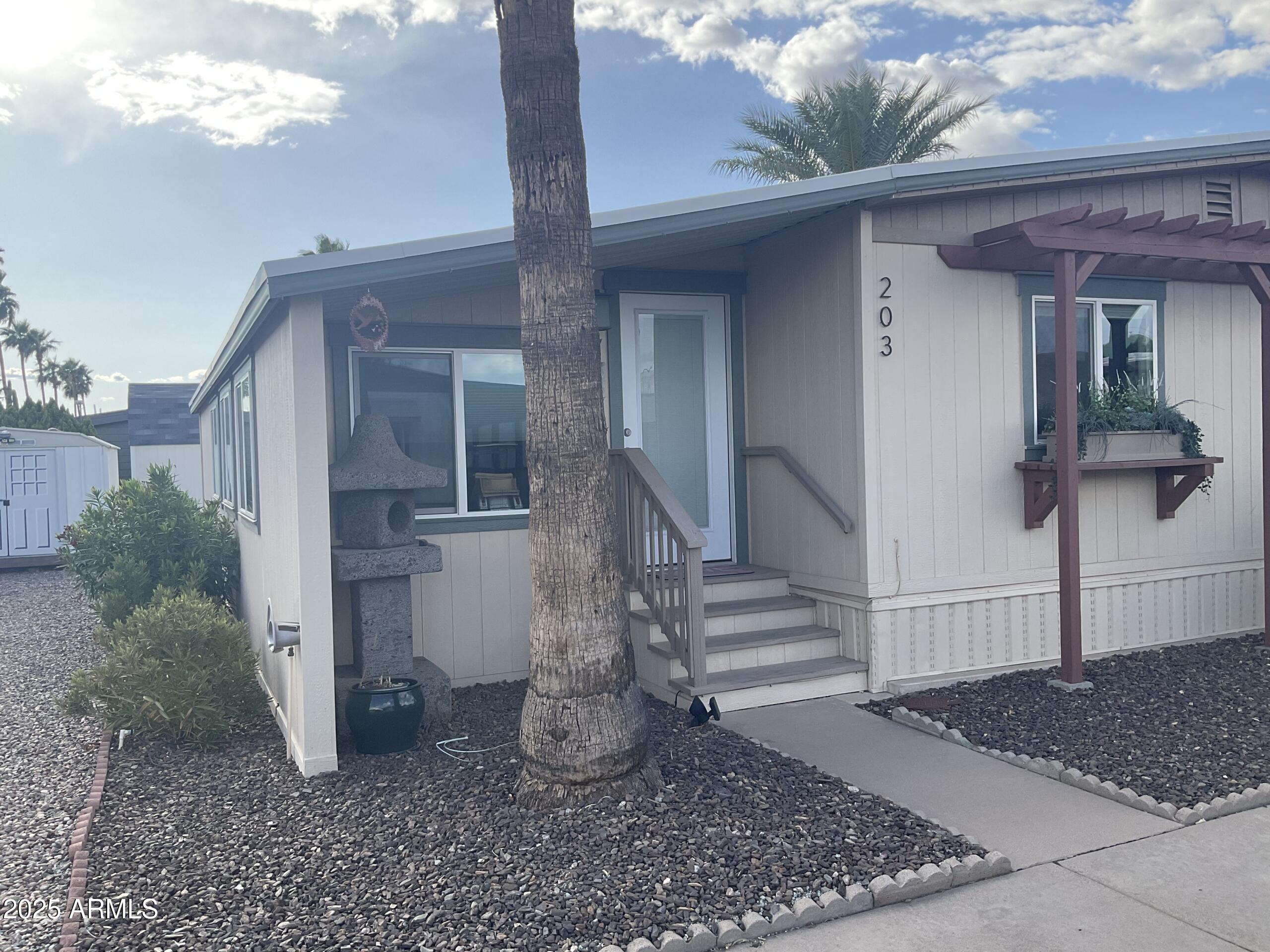 2175 West Southern Avenue, Unit 203 Apache Junction, AZ 85120 - Photo 25 of 28 a view of a house with a yard