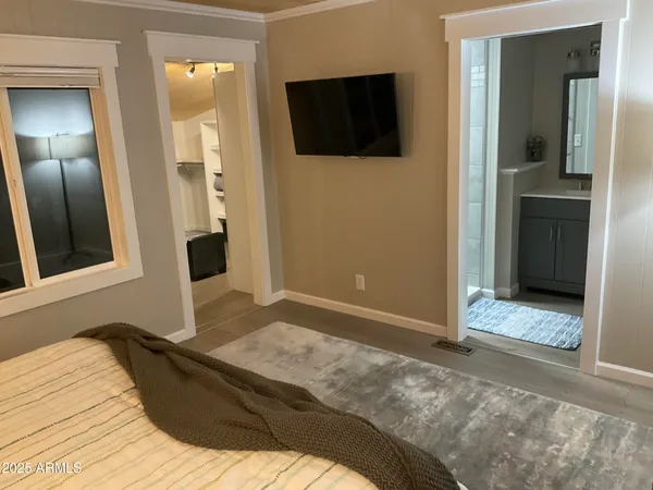 a bedroom with a bed and a flat screen tv