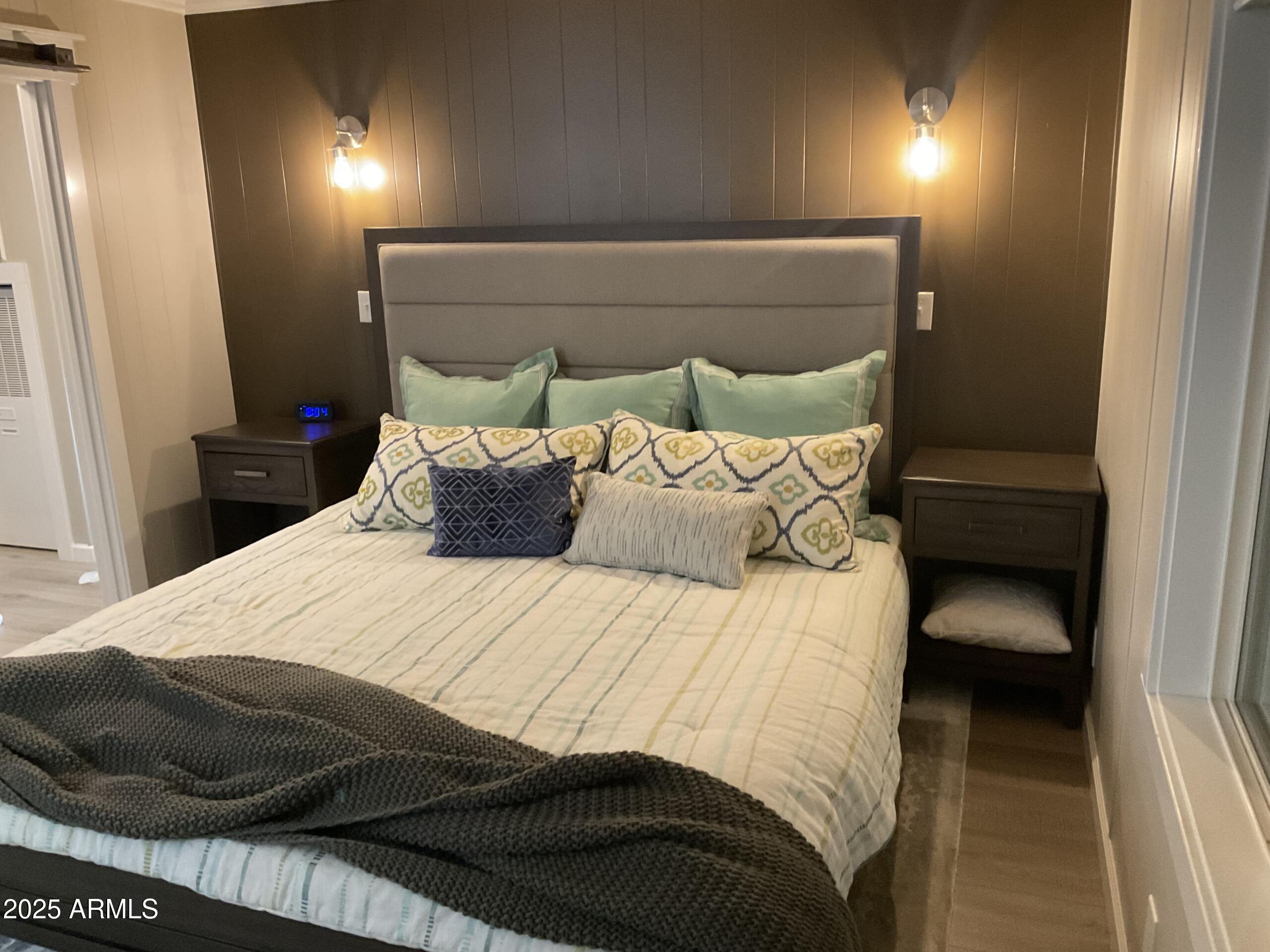 2175 West Southern Avenue, Unit 203 Apache Junction, AZ 85120 - Photo 27 of 28 a bedroom with a bed and a night stand