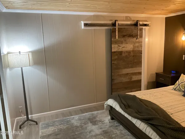 a bedroom with a bed and a shower