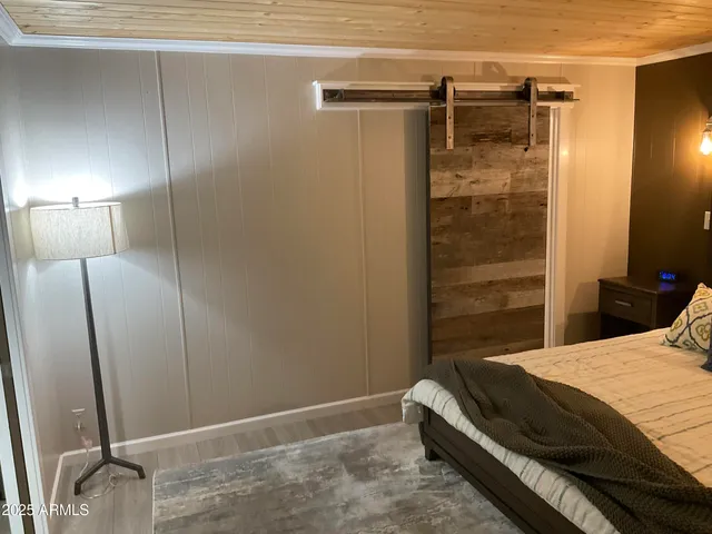 a bedroom with a bed and a shower