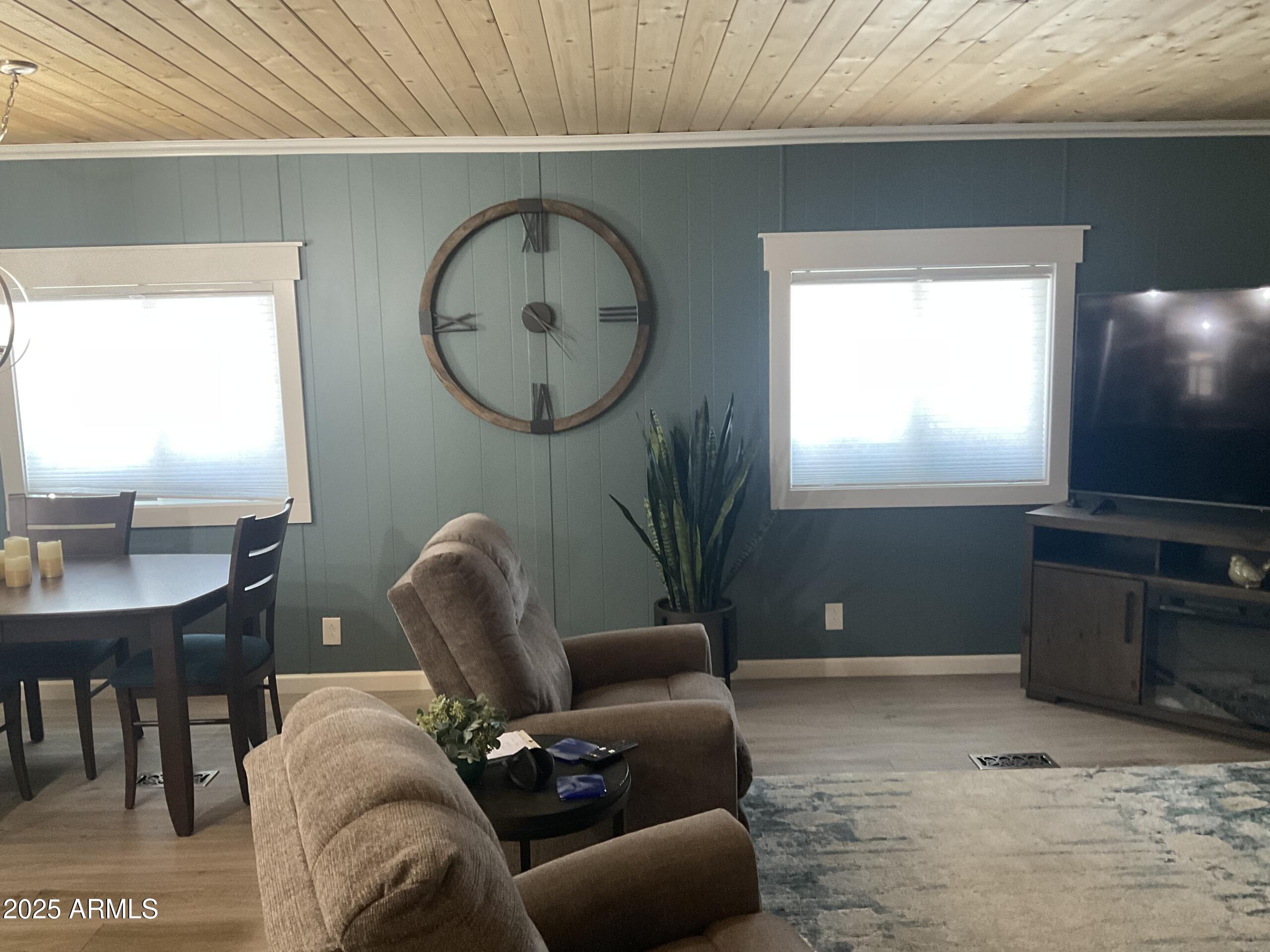 2175 West Southern Avenue, Unit 203 Apache Junction, AZ 85120 - Photo 10 of 28 a living room with furniture a window and a flat screen tv