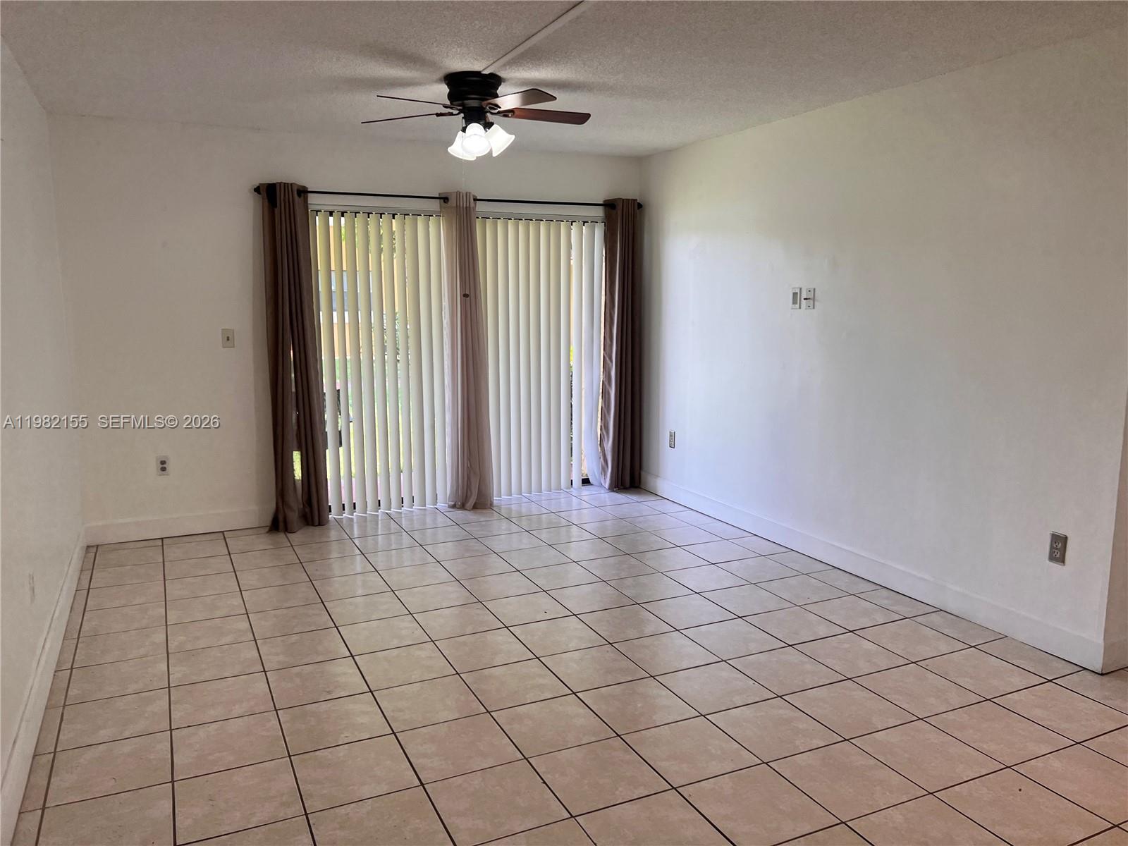 15610 Southwest 80th Street, Unit J105 Miami, FL 33193 - Photo 19 of 38 an empty room with windows and fan
