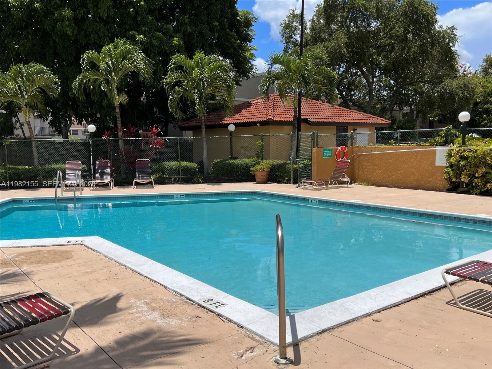 15610 Southwest 80th Street, Unit J105 Miami, FL 33193 - Photo 26 of 38 a view of a house with pool and a yard