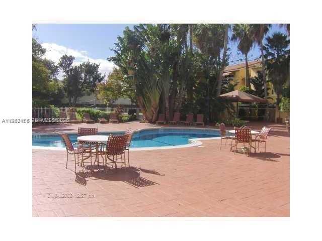 15610 Southwest 80th Street, Unit J105 Miami, FL 33193 - Photo 32 of 38 a view of a outdoor space with seating area