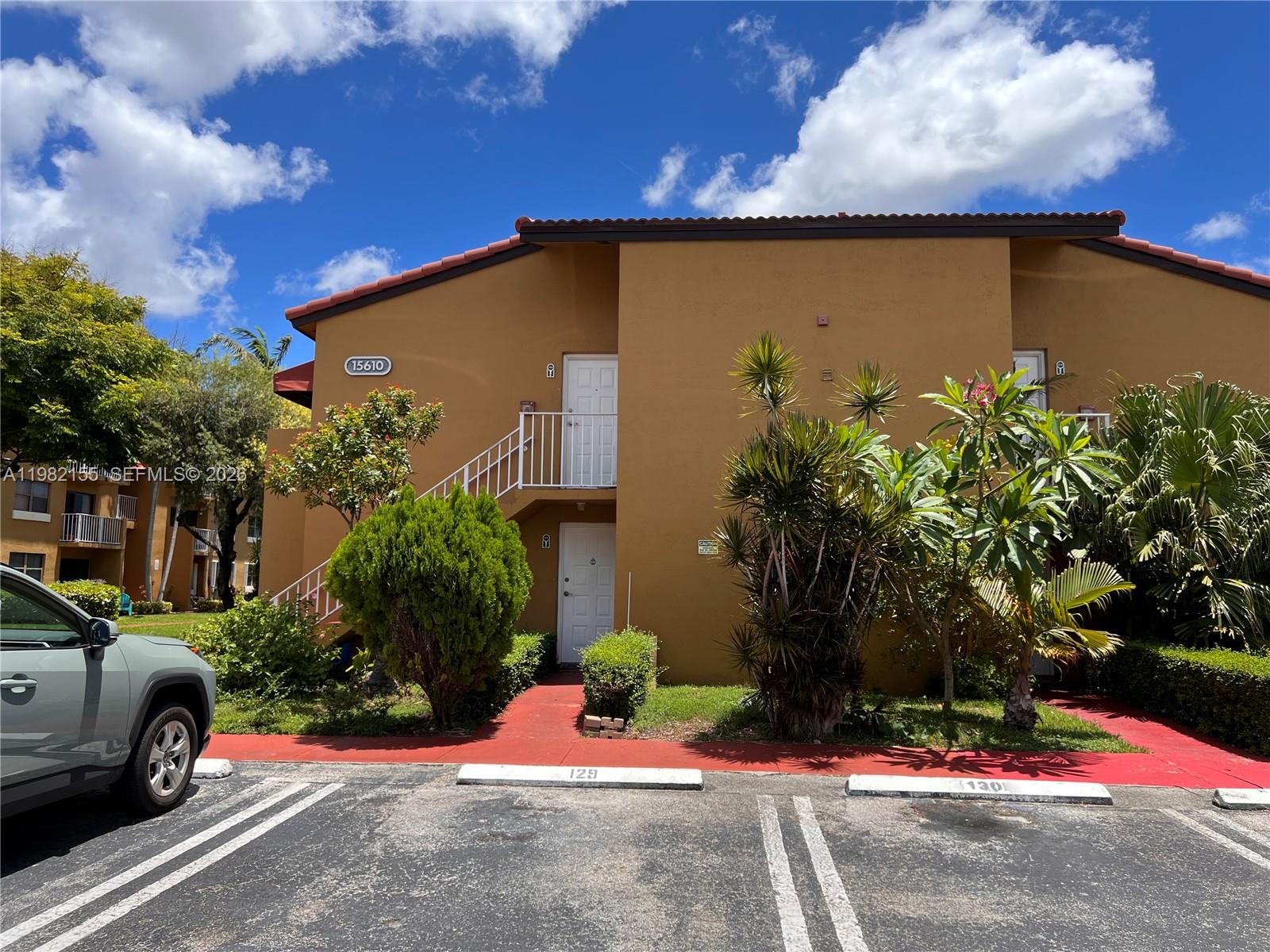 15610 Southwest 80th Street, Unit J105 Miami, FL 33193 - Photo 38 of 38 a view of a street with a car parked in front of it