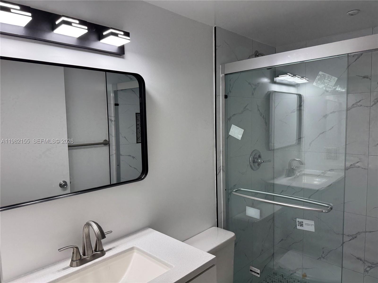 15610 Southwest 80th Street, Unit J105 Miami, FL 33193 - Photo 5 of 38 a bathroom with a sink and mirror