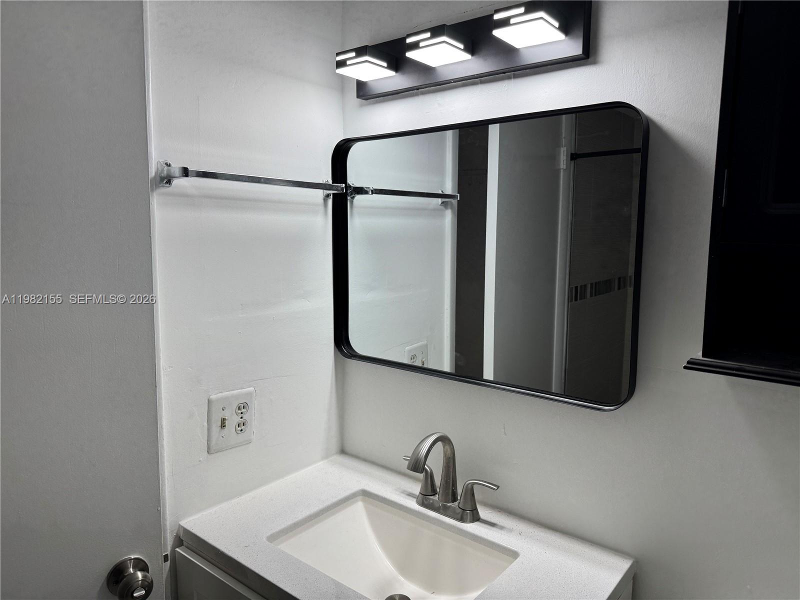 15610 Southwest 80th Street, Unit J105 Miami, FL 33193 - Photo 9 of 38 a bathroom with a sink and mirror
