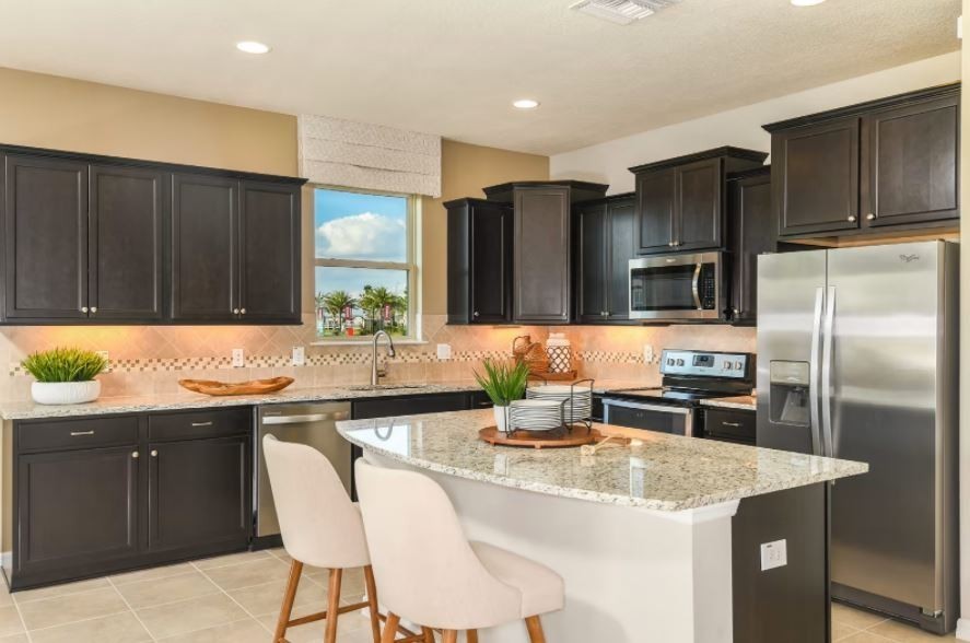 a kitchen with granite countertop a sink and stainless steel appliances