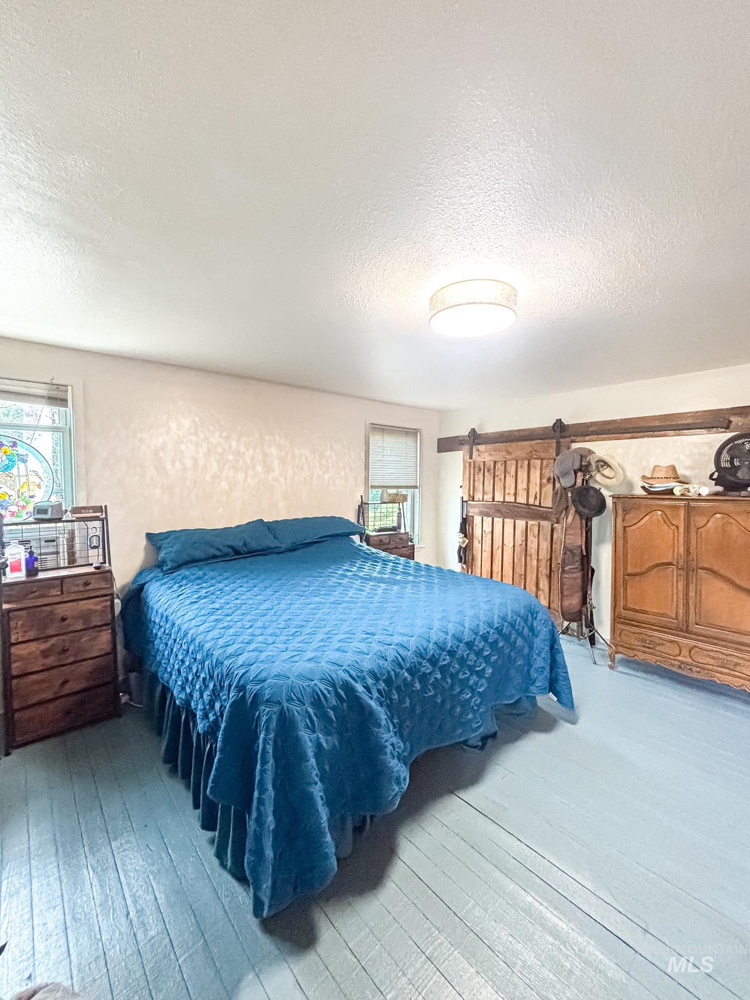 1995 Glenwood Road Kamiah, ID 83536 - Photo 25 of 38 Painted wood-finish flooring with a flush-mount ceiling light fixture. Master bedroom Upper level