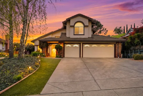 a front view of a house with garden