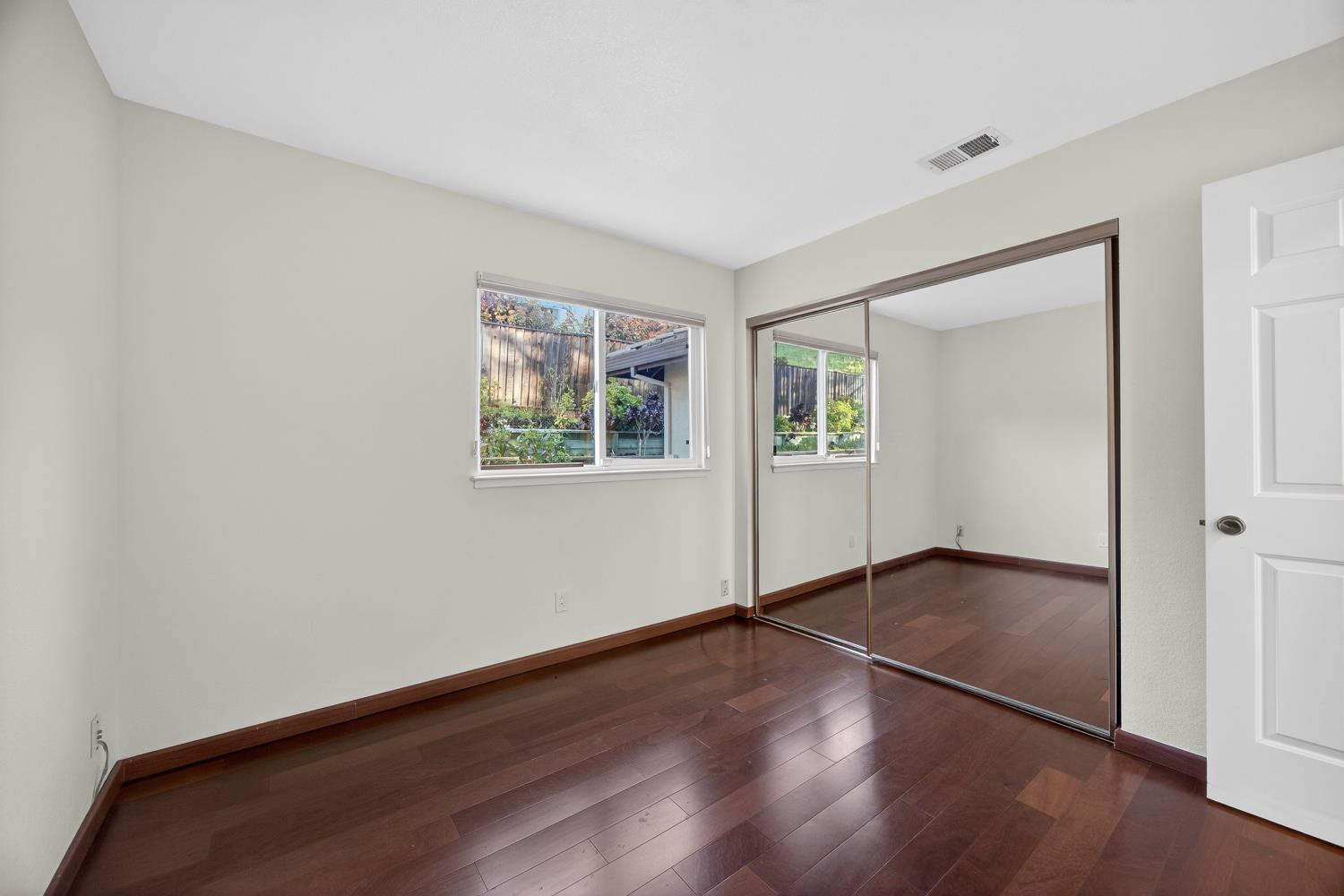 248 Carson Street Hercules, CA 94547 - Photo 27 of 70 an empty room with wooden floor closet and windows