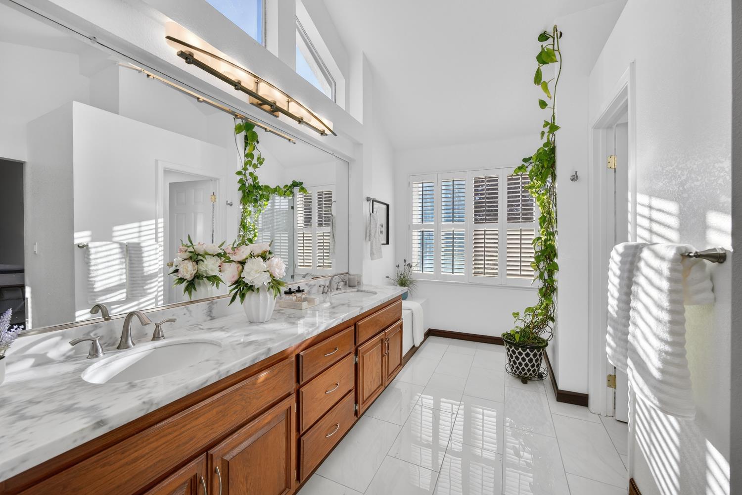 248 Carson Street Hercules, CA 94547 - Photo 35 of 70 a spacious bathroom with a granite countertop sink a mirror and a bathtub