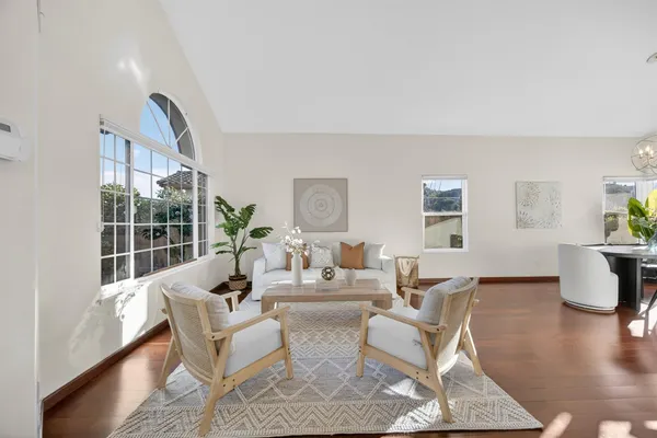 a view of a dining room with furniture and wooden floor