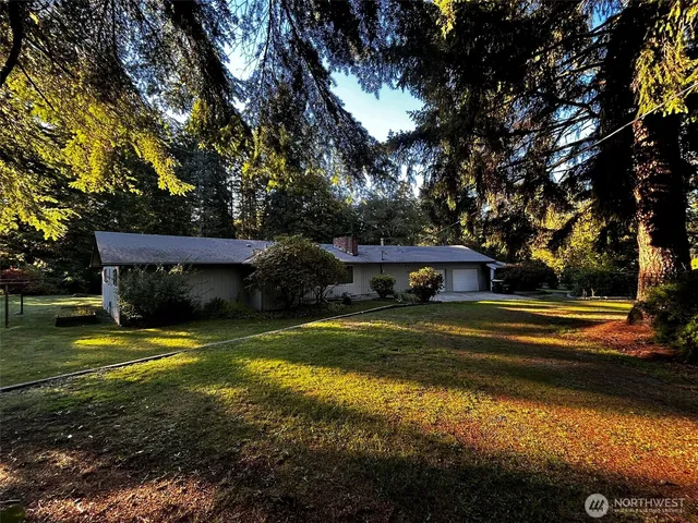 a view of a house with swimming pool yard and trees