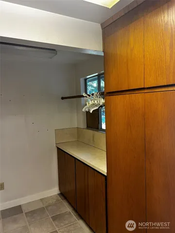 a view of a livingroom with furniture and a kitchen