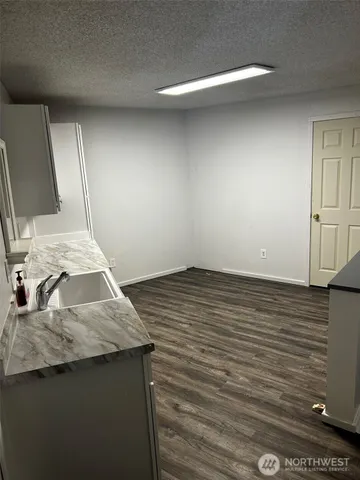 a view of a swimming pool with a patio and a yard