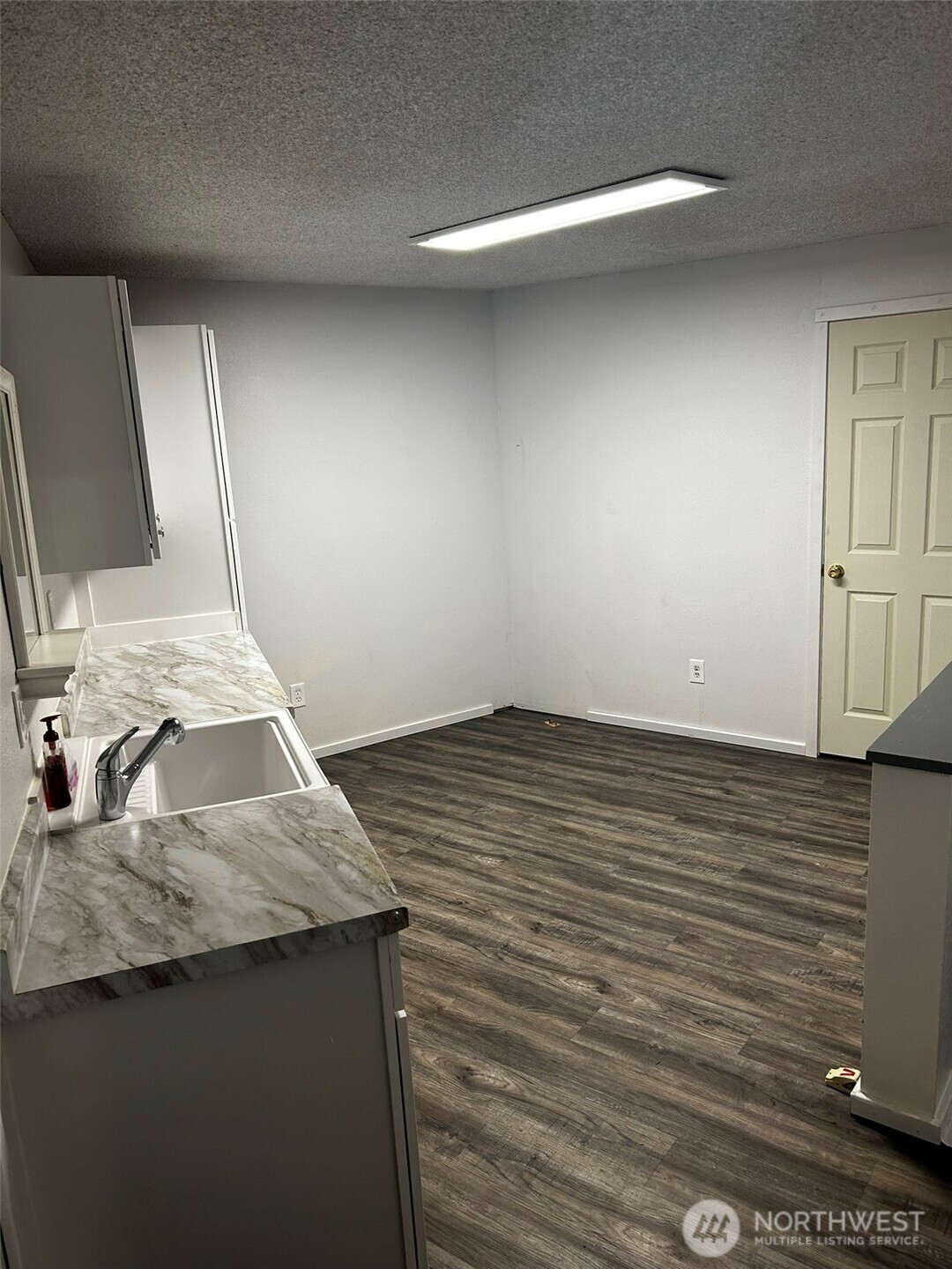 4131 Delphi Road Southwest Olympia, WA 98512 - Photo 27 of 39 a kitchen with a sink cabinets and wooden floor