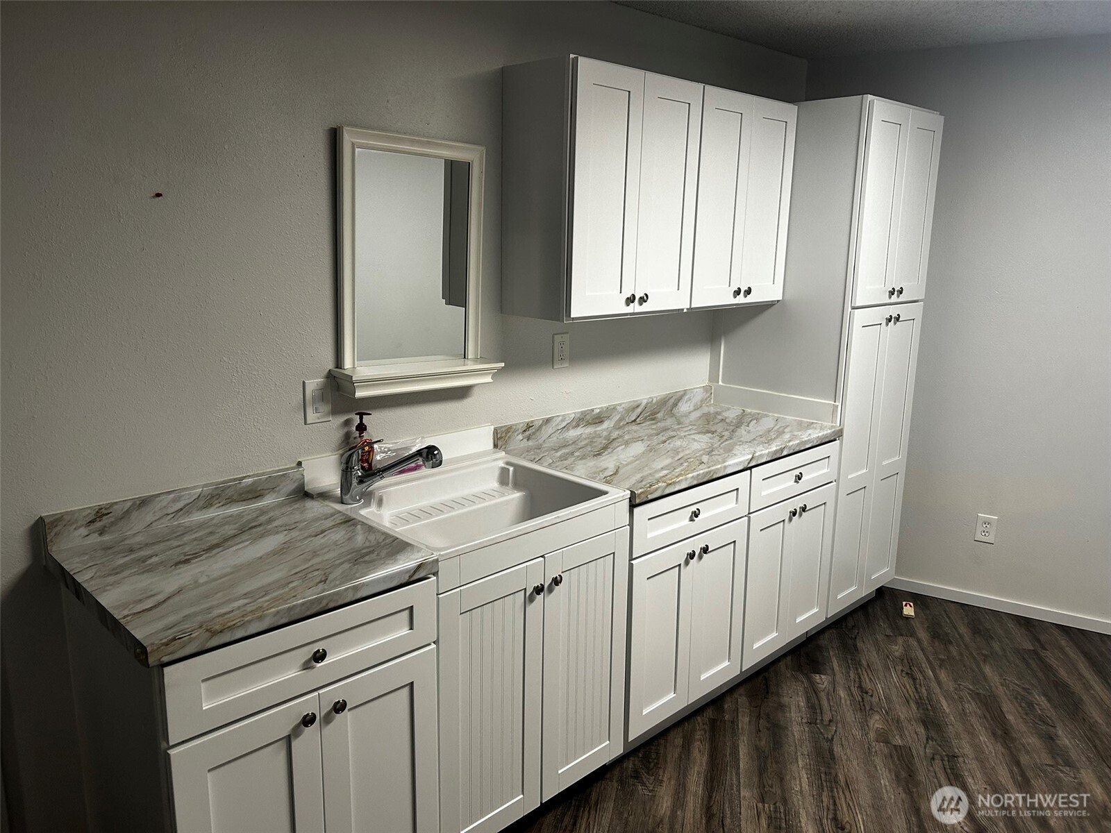 4131 Delphi Road Southwest Olympia, WA 98512 - Photo 28 of 39 a kitchen with granite countertop white cabinets and sink