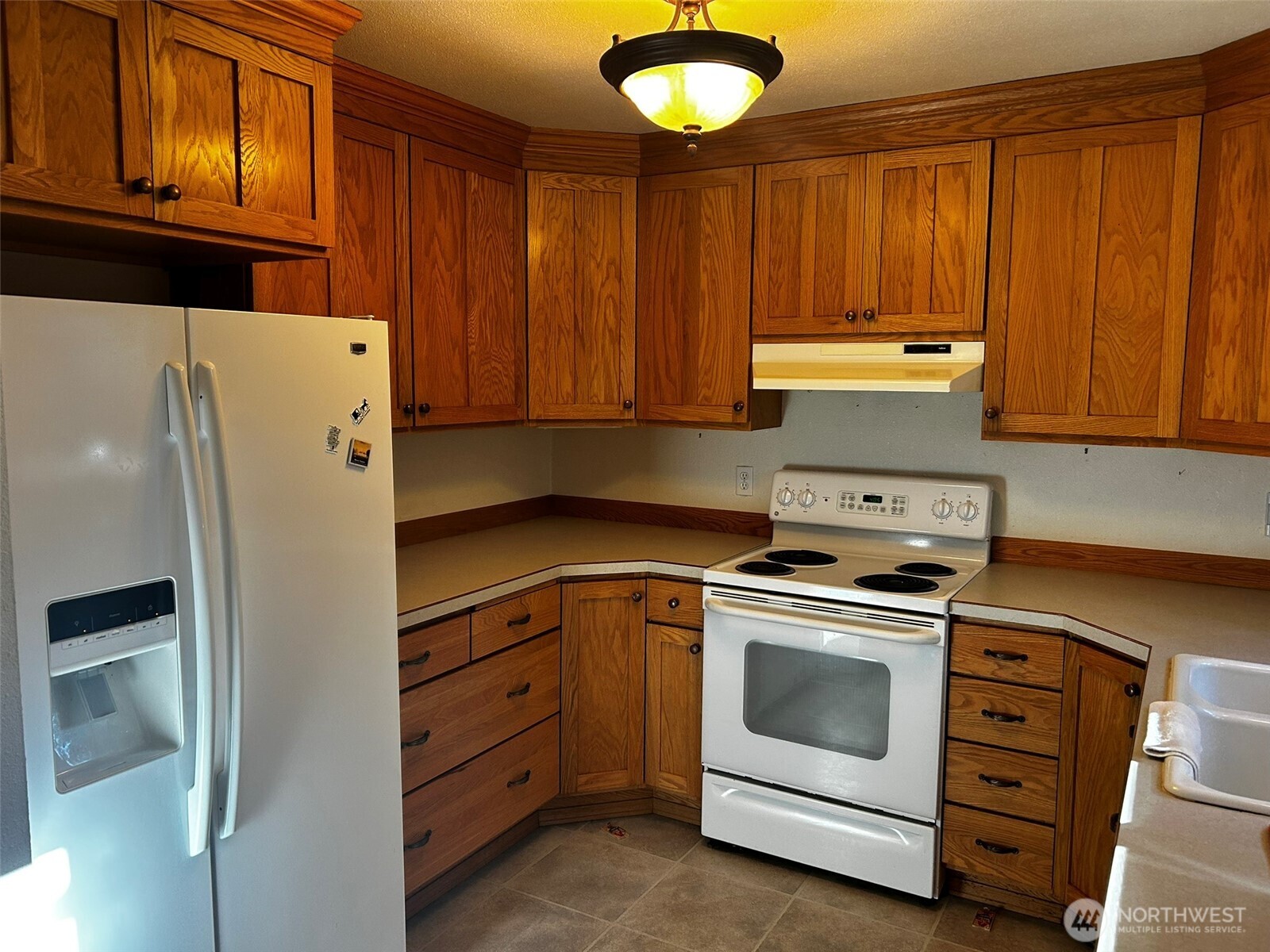 4131 Delphi Road Southwest Olympia, WA 98512 - Photo 4 of 39 a kitchen with a stove and a refrigerator