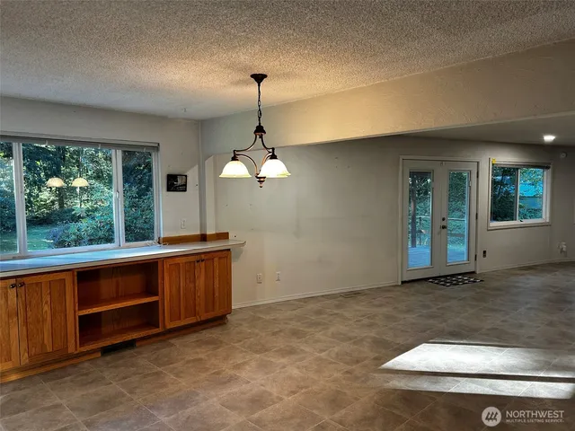 a view of empty room with wooden floor and fireplace