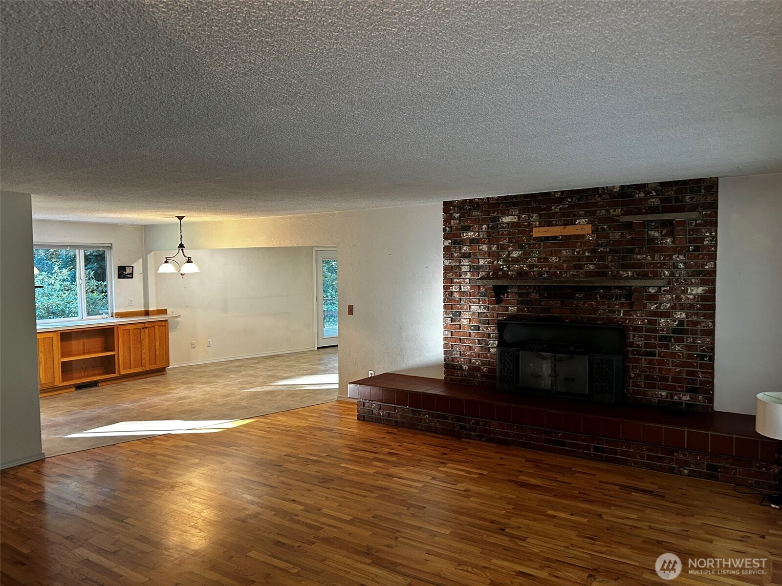 4131 Delphi Road Southwest Olympia, WA 98512 - Photo 7 of 39 a view of empty room with wooden floor and fireplace