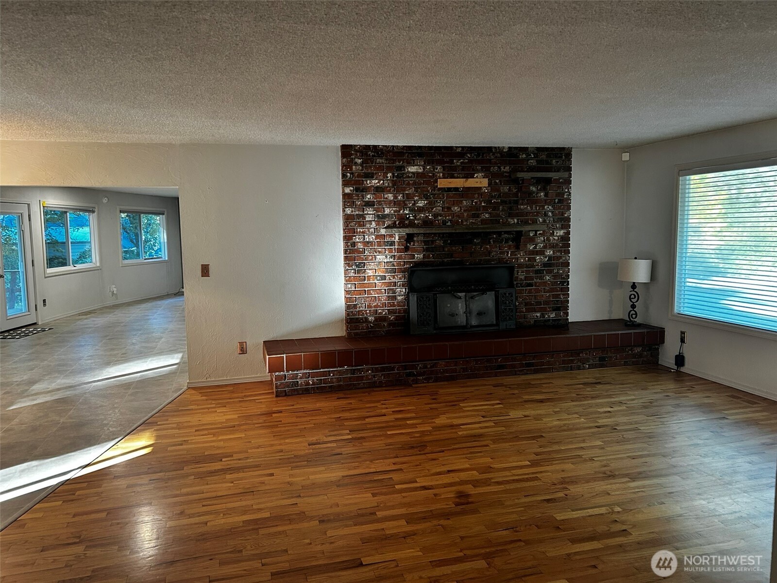 4131 Delphi Road Southwest Olympia, WA 98512 - Photo 8 of 39 a living room with fireplace furniture and a large window