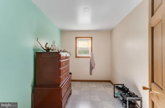 a bedroom with furniture and a window