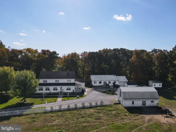 a aerial view of a house with swimming pool and a yard
