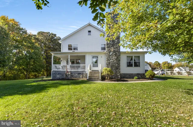 a view of house with backyard