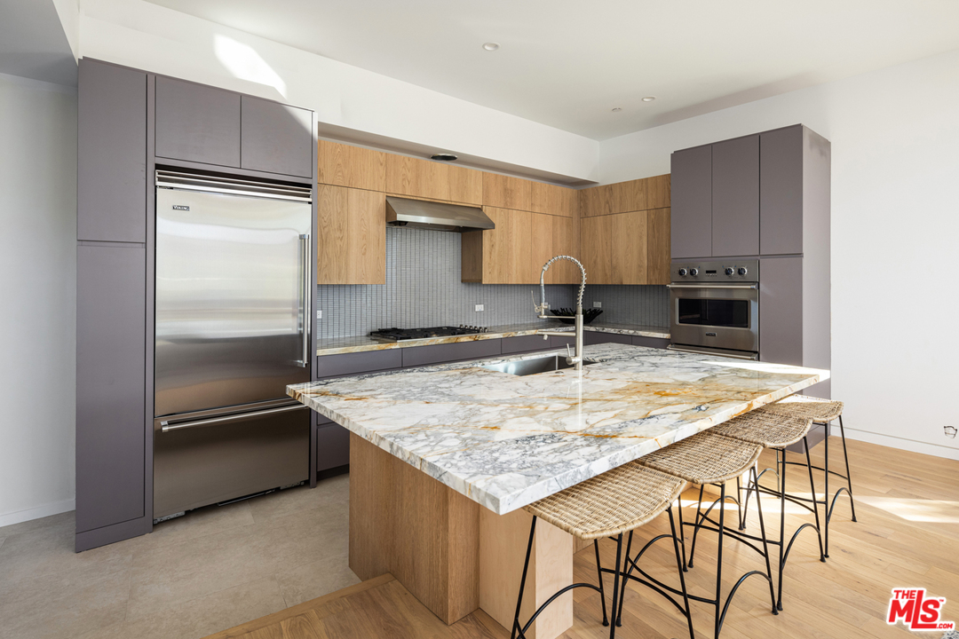 700 Brooks Avenue Venice, CA 90291 - Photo 21 of 53 a kitchen with kitchen island a counter top space cabinets and stainless steel appliances