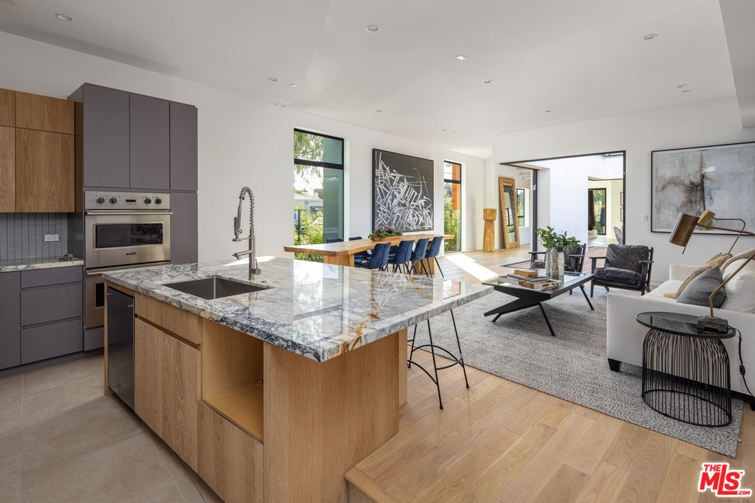 700 Brooks Avenue Venice, CA 90291 - Photo 23 of 53 a kitchen with stainless steel appliances granite countertop a stove top oven a sink dishwasher and couches with wooden floor
