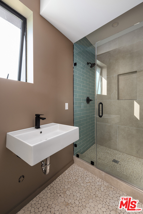 700 Brooks Avenue Venice, CA 90291 - Photo 41 of 53 a bathroom with a sink a mirror and shower