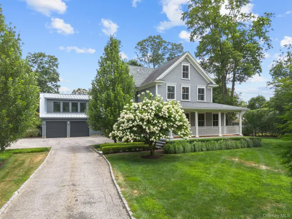 a house with a big yard and large trees