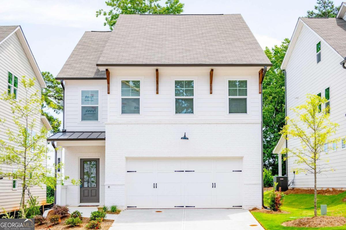 a front view of a house with garden