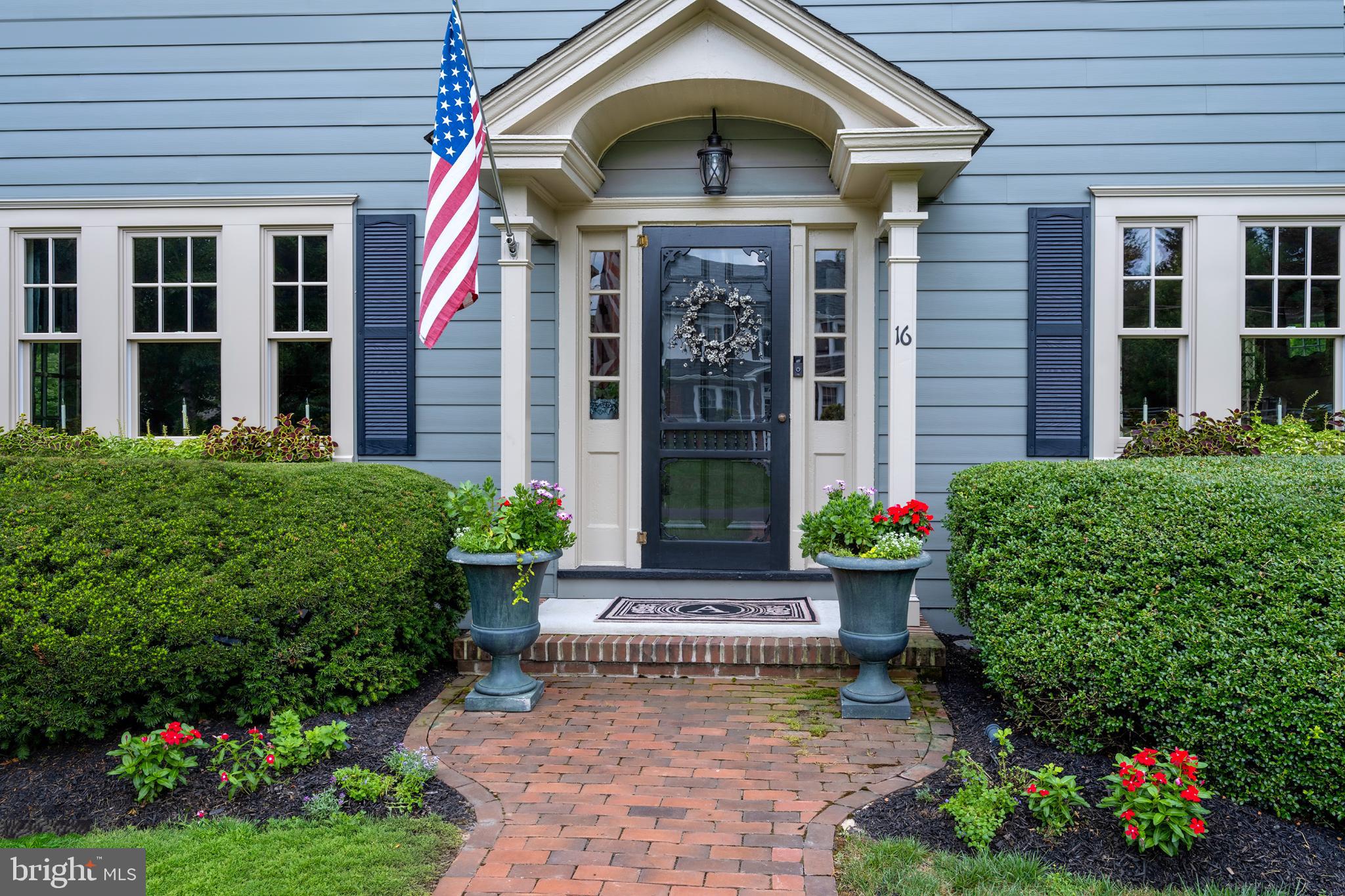 16 Effingham Road Yardley, PA 19067 - Photo 33 of 33 Charming entrance with lush greenery and flag.