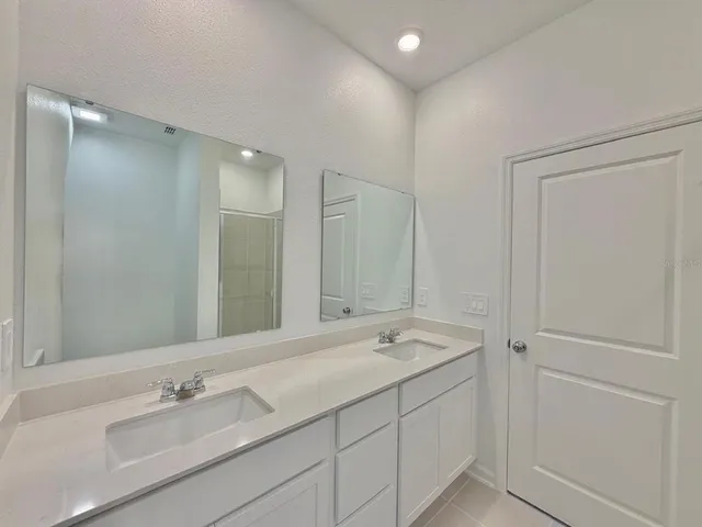 a bathroom with a sink toilet and mirror
