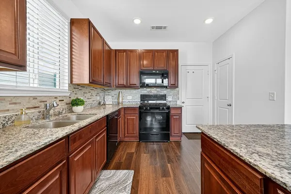 a kitchen with a sink stove and refrigerator