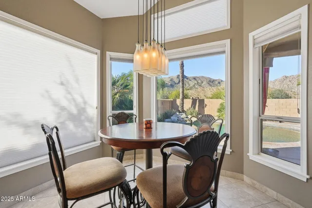 a dining room with furniture a chandelier and wooden floor