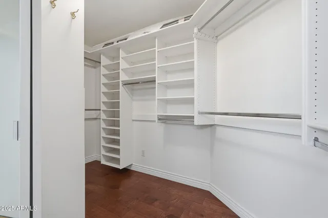 a view of walk in closet with empty racks