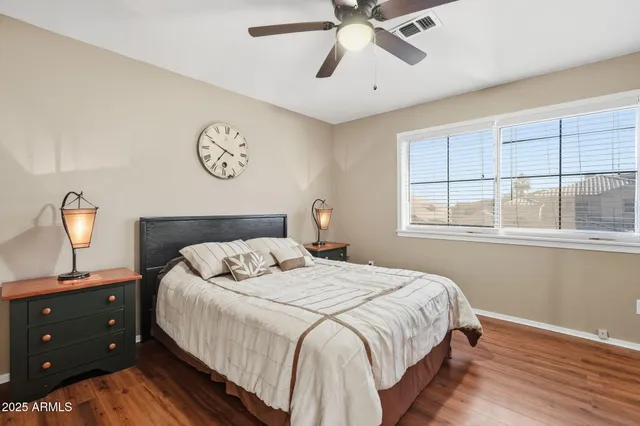 a bedroom with a bed and window with lamp