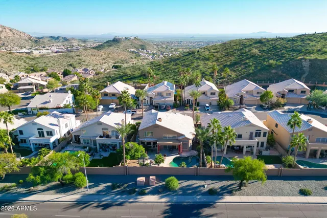 an aerial view of residential houses with outdoor space