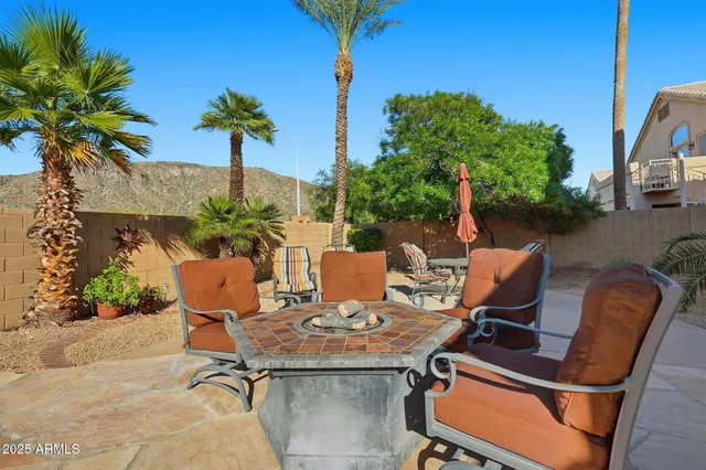 a backyard of a house with table and chairs