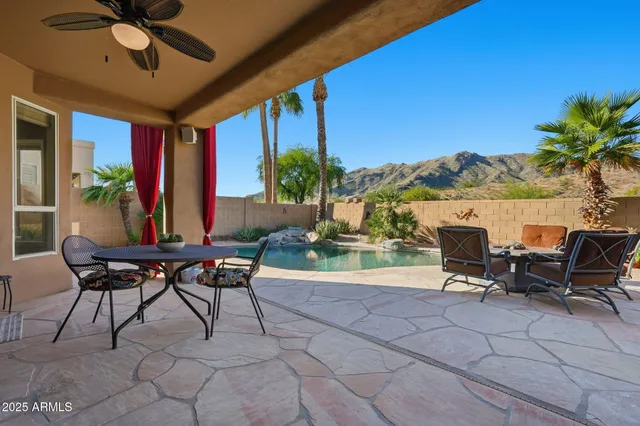 a view of a patio with table and chairs and potted plants
