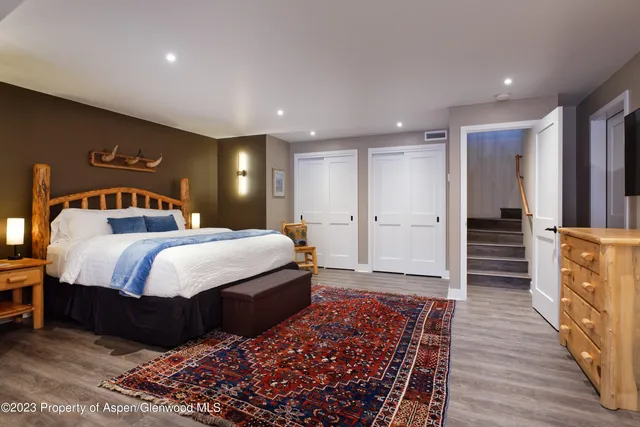 a bedroom with a large bed and a dresser